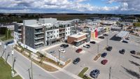 aerial view of a TerraBridge mixed-use development with lofts and a commercial plaza